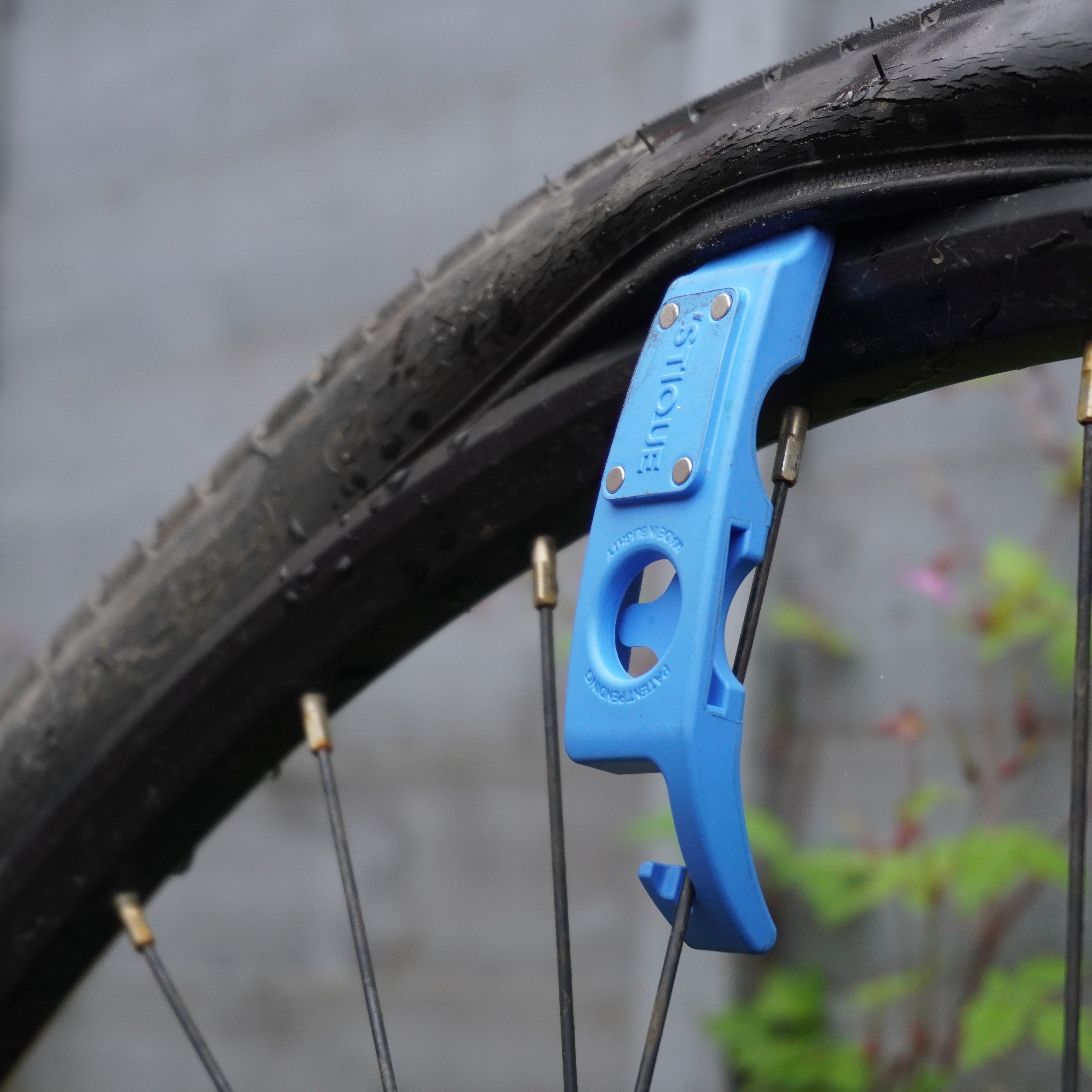 ML14 bike tyre lever hooked onto spokes of a mountain bike wheel