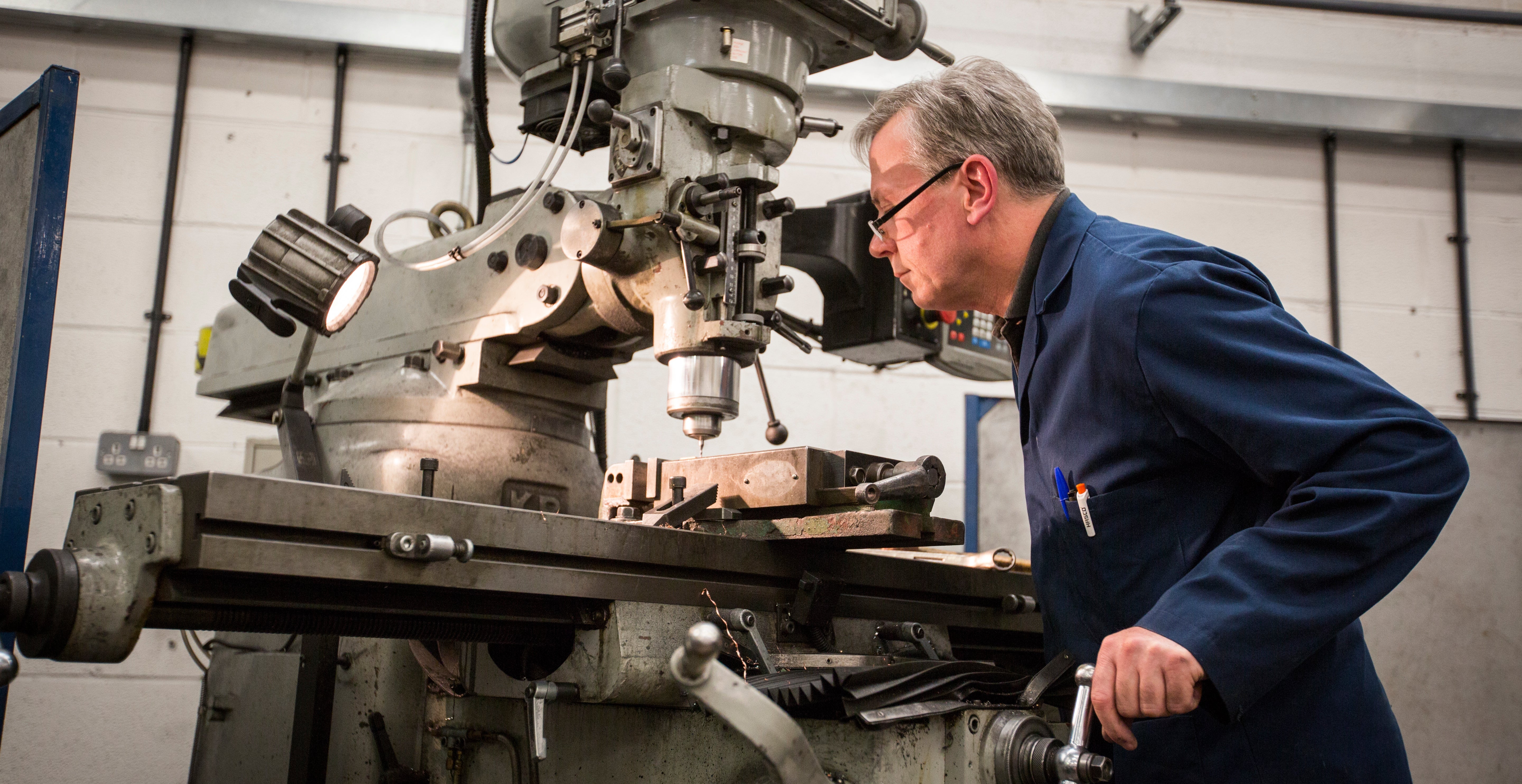 Engineer working on milling machine in UK manufacturing facility for Stique bike tools