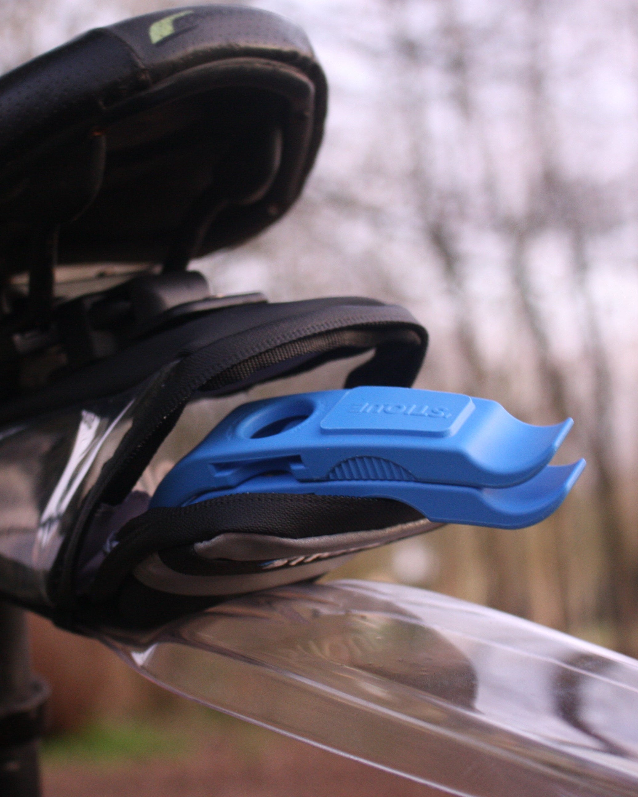 Blue ML14 bike tyre levers stored inside a saddle bag under a bicycle seat