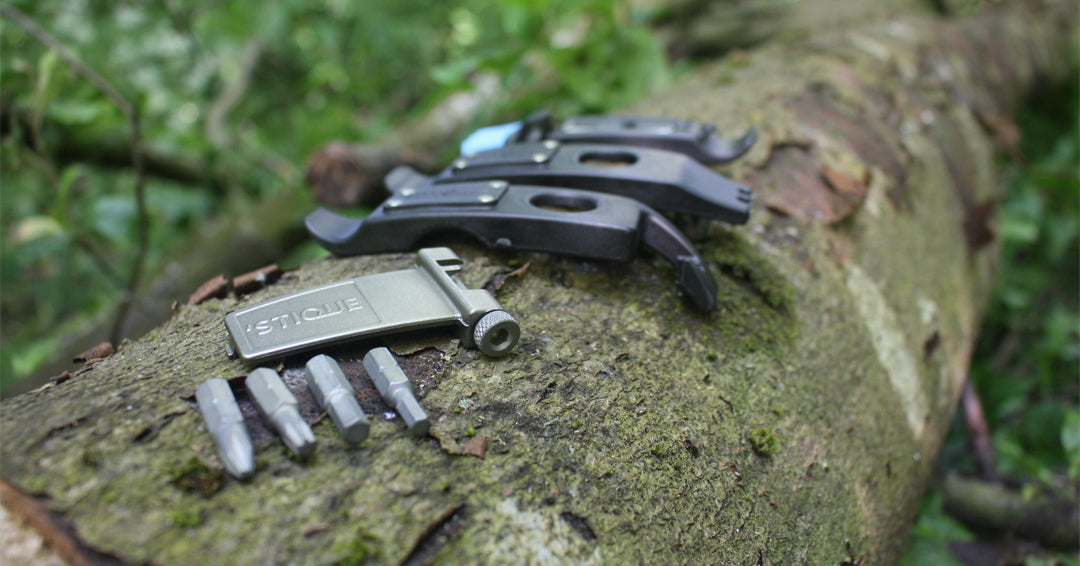 Stique ML125 bike multi-tool with tyre levers and hex bits on tree trunk